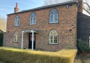 Picture of brick cottage with pointed arched windows